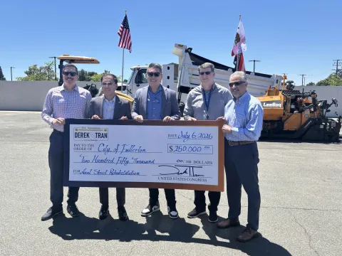 Congressman Derek Tran presenting a check of $250,000 to Fullerton city leaders.